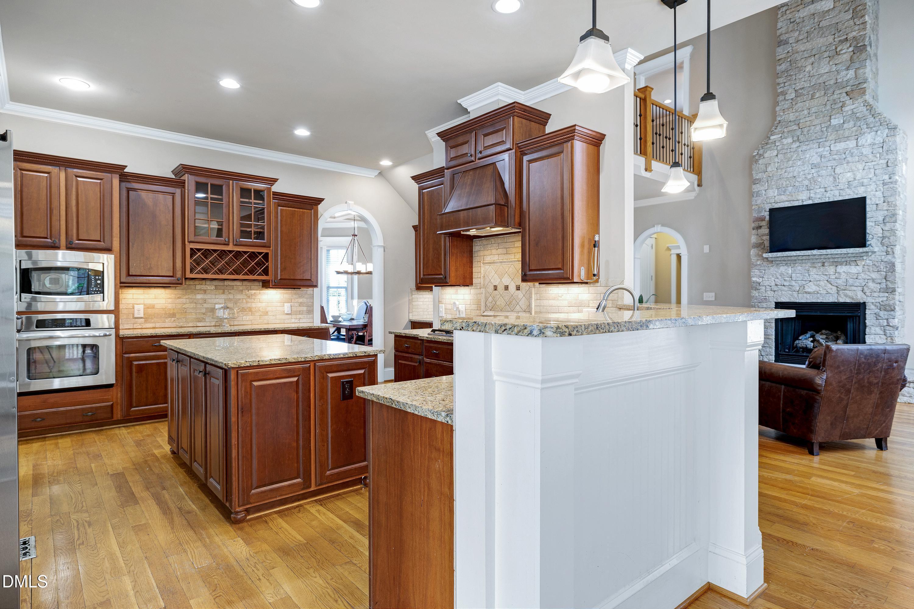 14212 Careme Court Wake Forest, NC 27587 - Photo 19 of 54 a kitchen with stainless steel appliances granite countertop a stove refrigerator and cabinets