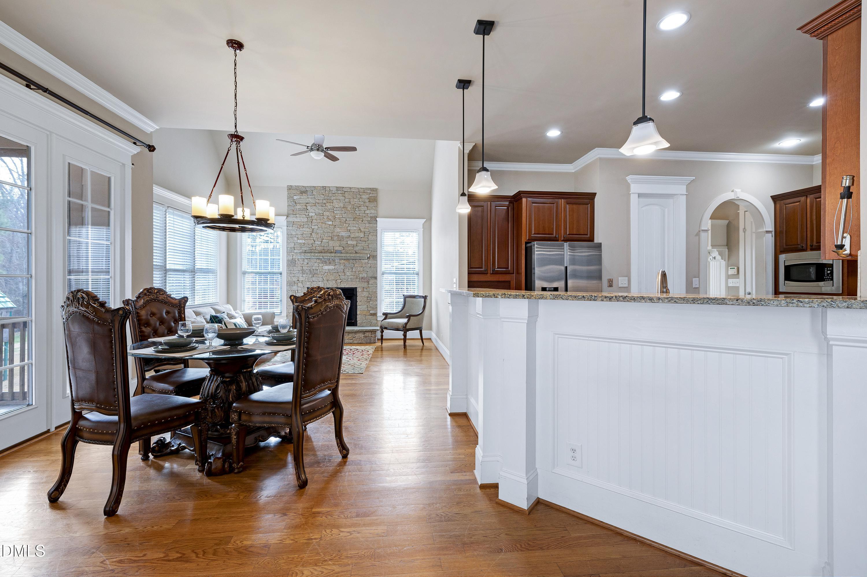 14212 Careme Court Wake Forest, NC 27587 - Photo 20 of 54 a view of a dining room and livingroom with furniture wooden floor a chandelier