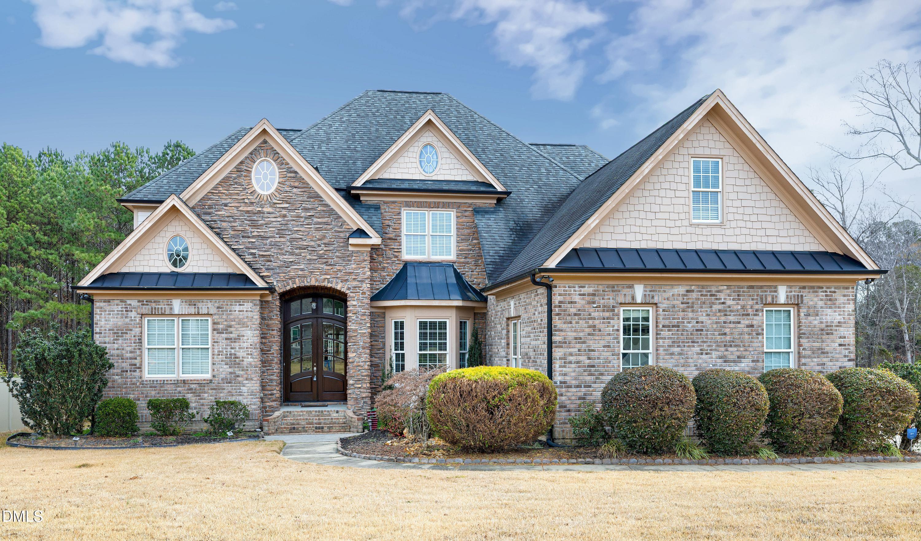 14212 Careme Court Wake Forest, NC 27587 - Photo 2 of 54 a front view of a house with a yard