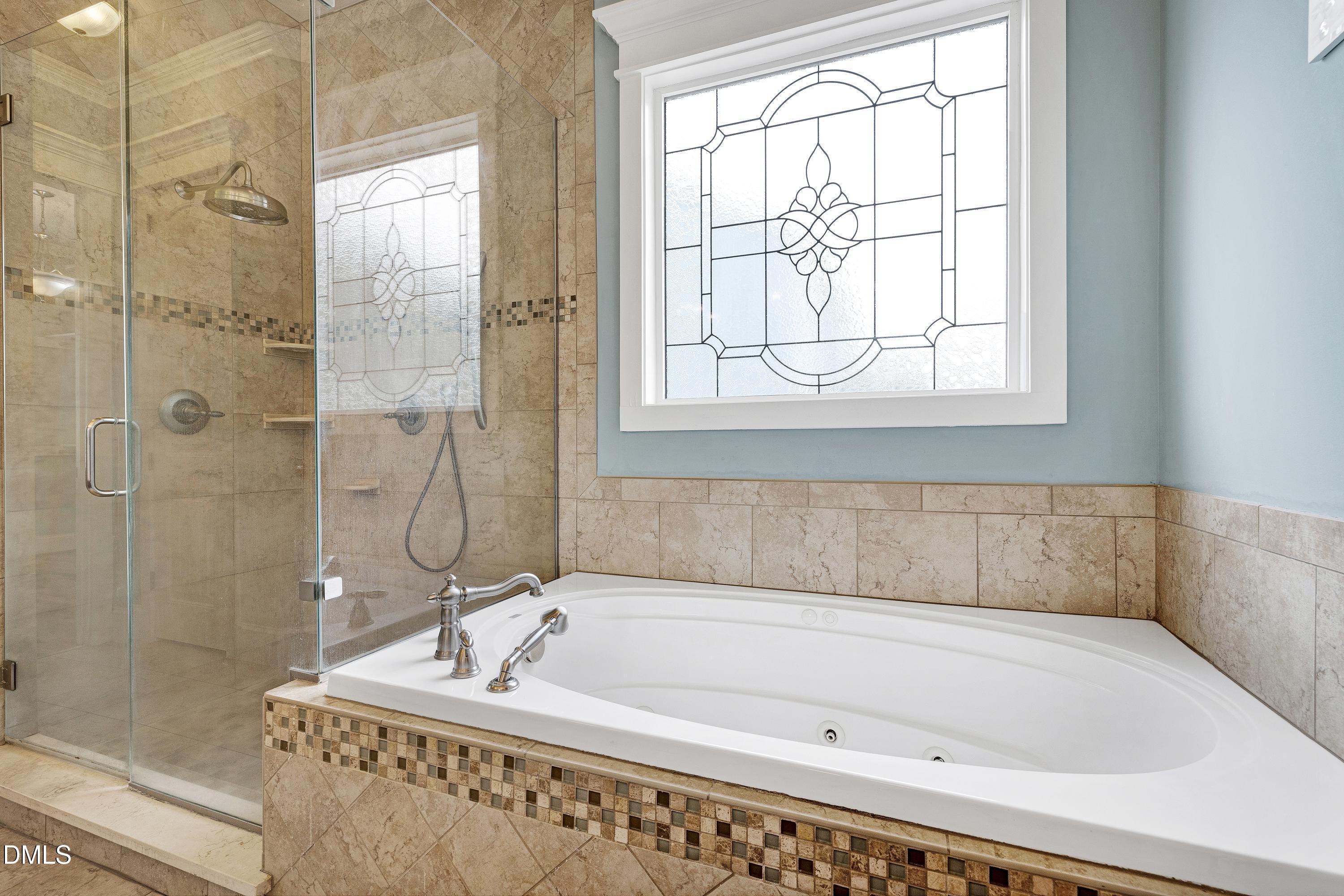 14212 Careme Court Wake Forest, NC 27587 - Photo 27 of 54 a bathroom with a bathtub and shower