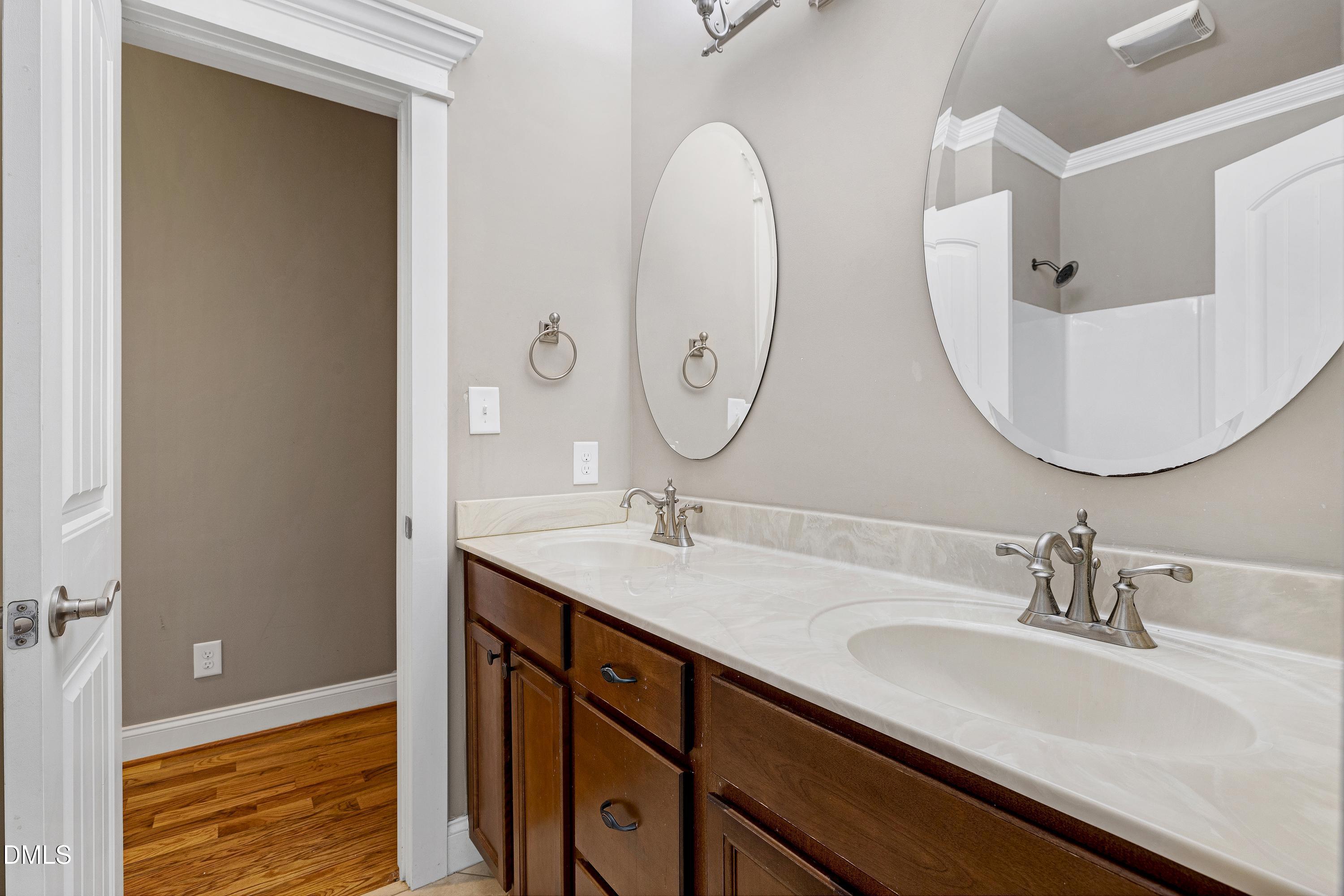 14212 Careme Court Wake Forest, NC 27587 - Photo 28 of 54 a bathroom with a double vanity sink and a mirror