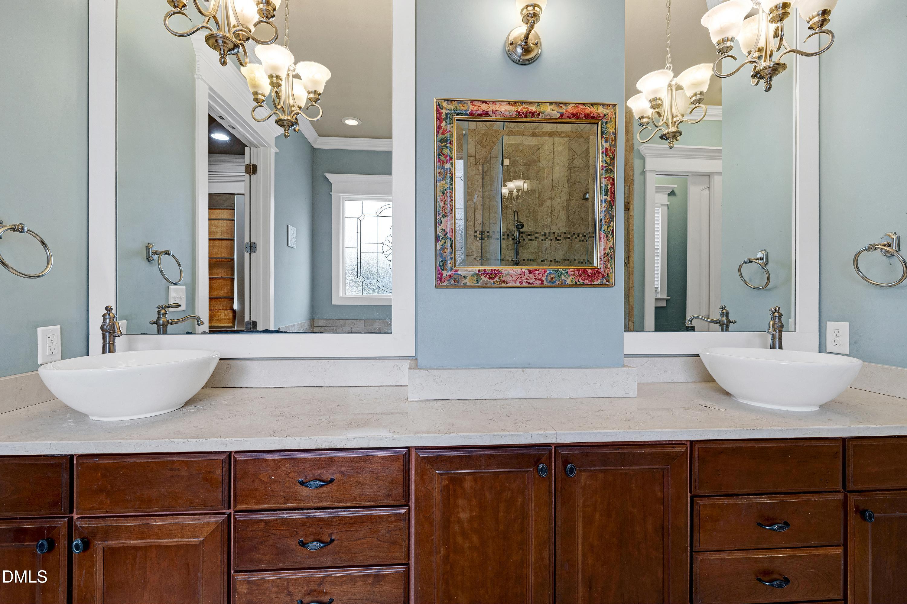 14212 Careme Court Wake Forest, NC 27587 - Photo 31 of 54 a bathroom with a granite countertop sink and a mirror