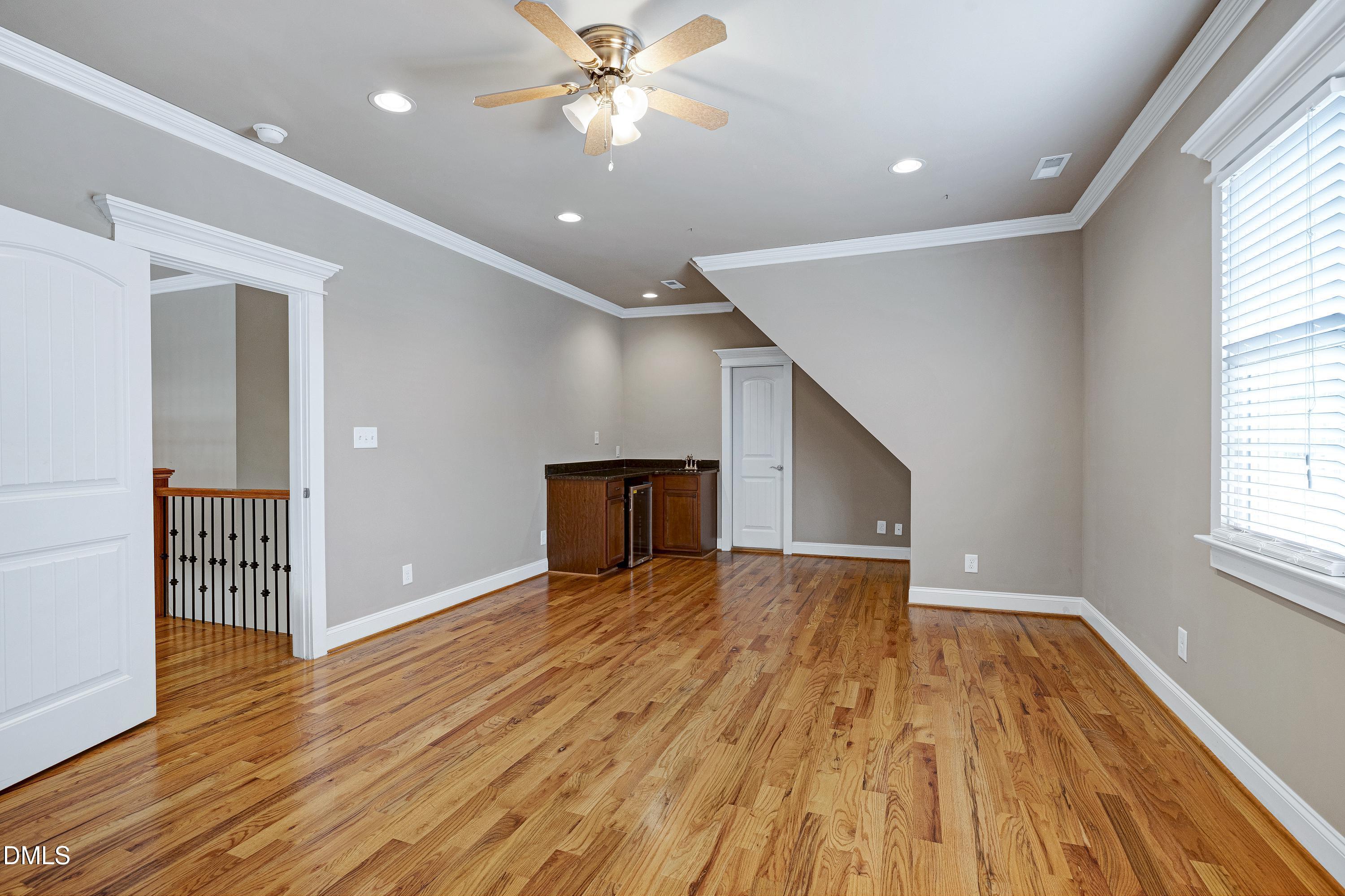 14212 Careme Court Wake Forest, NC 27587 - Photo 36 of 54 a view of empty room with wooden floor and fan