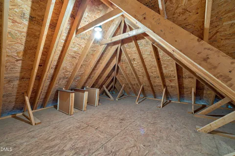 a view of a livingroom with wooden floor and stairs