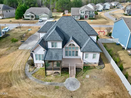 a view of a house with a patio and a yard