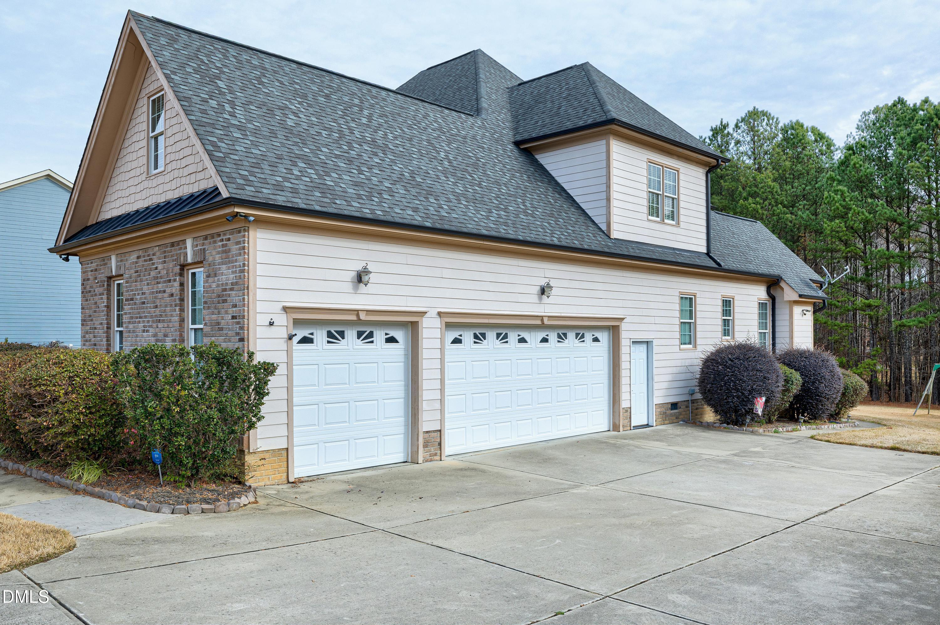 14212 Careme Court Wake Forest, NC 27587 - Photo 48 of 54 a front view of a house with a yard and garage