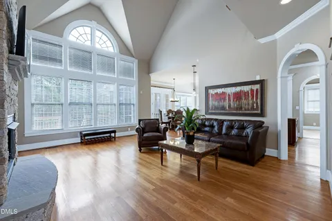 a living room with furniture and a floor to ceiling window