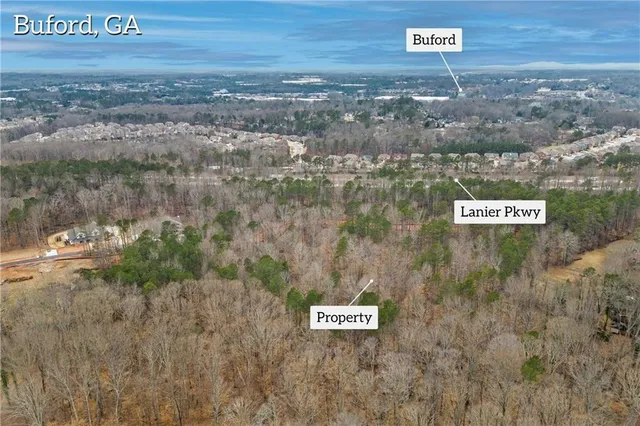 a view of a street with a bench and wooden fence