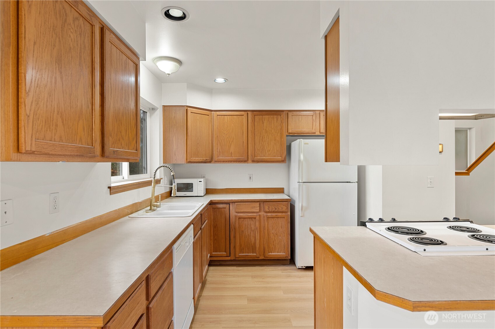 4733 Carlton Road Everett, WA 98203 - Photo 5 of 23 a kitchen with a sink a stove and cabinets