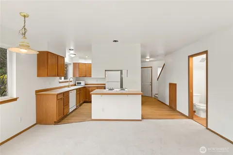 a kitchen with stainless steel appliances a refrigerator sink and stove