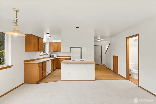 a kitchen with stainless steel appliances a refrigerator sink and stove