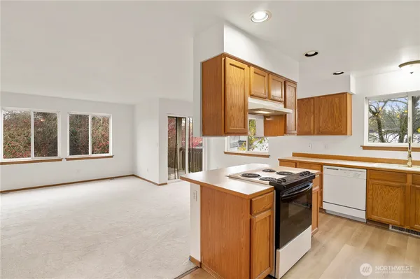 a kitchen that has a sink and a stove in it