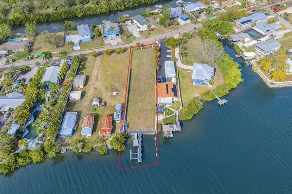 an aerial view of a house with garden space and lake view