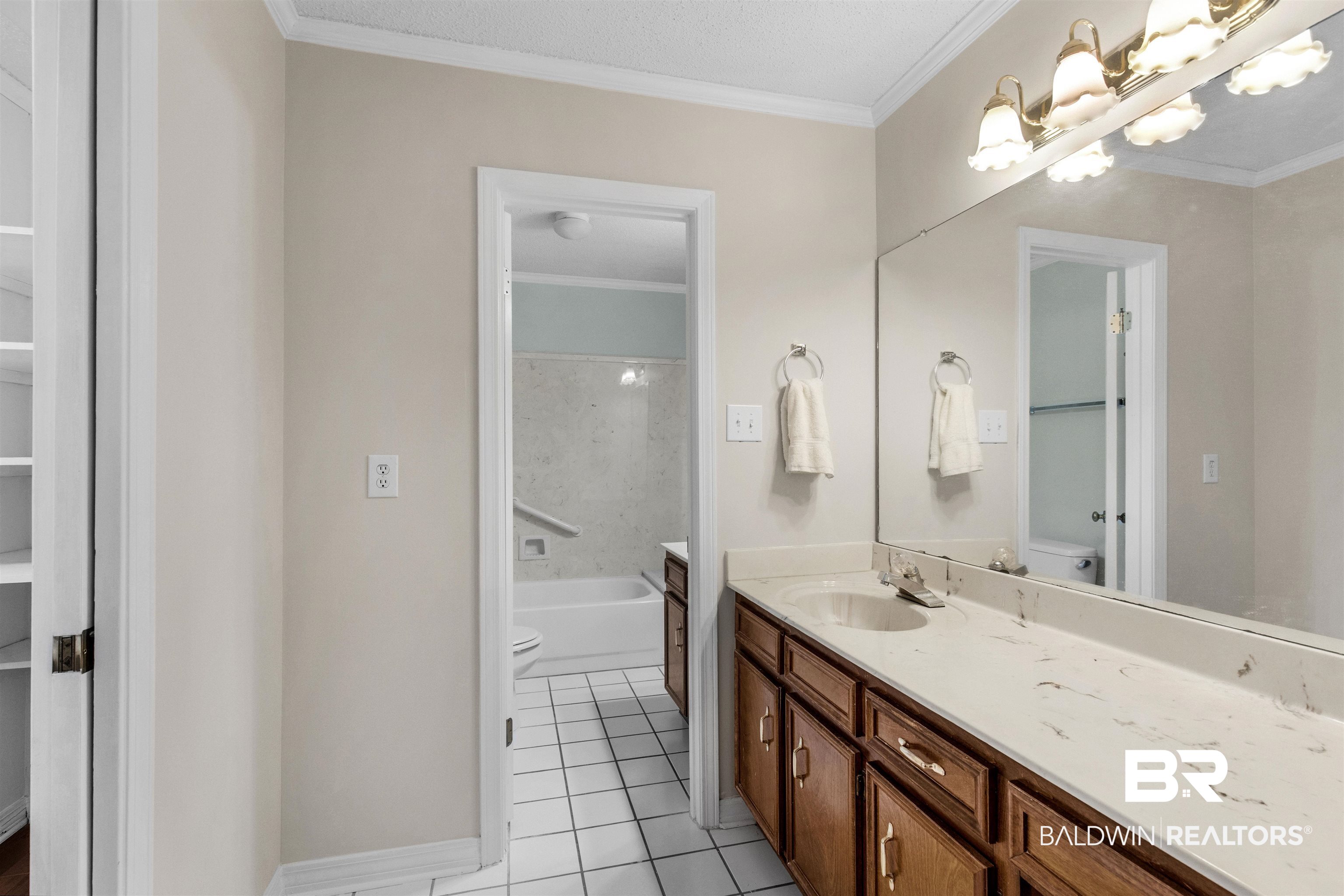 7225 Smithfield Road East Mobile, AL 36695 - Photo 18 of 27 Full bath featuring tile patterned flooring, toilet, vanity, and crown molding