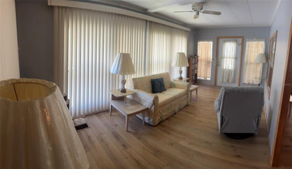 3301 Alt 19, Unit 314 Dunedin, FL 34698 - Photo 2 of 11 a living room with furniture and a large window