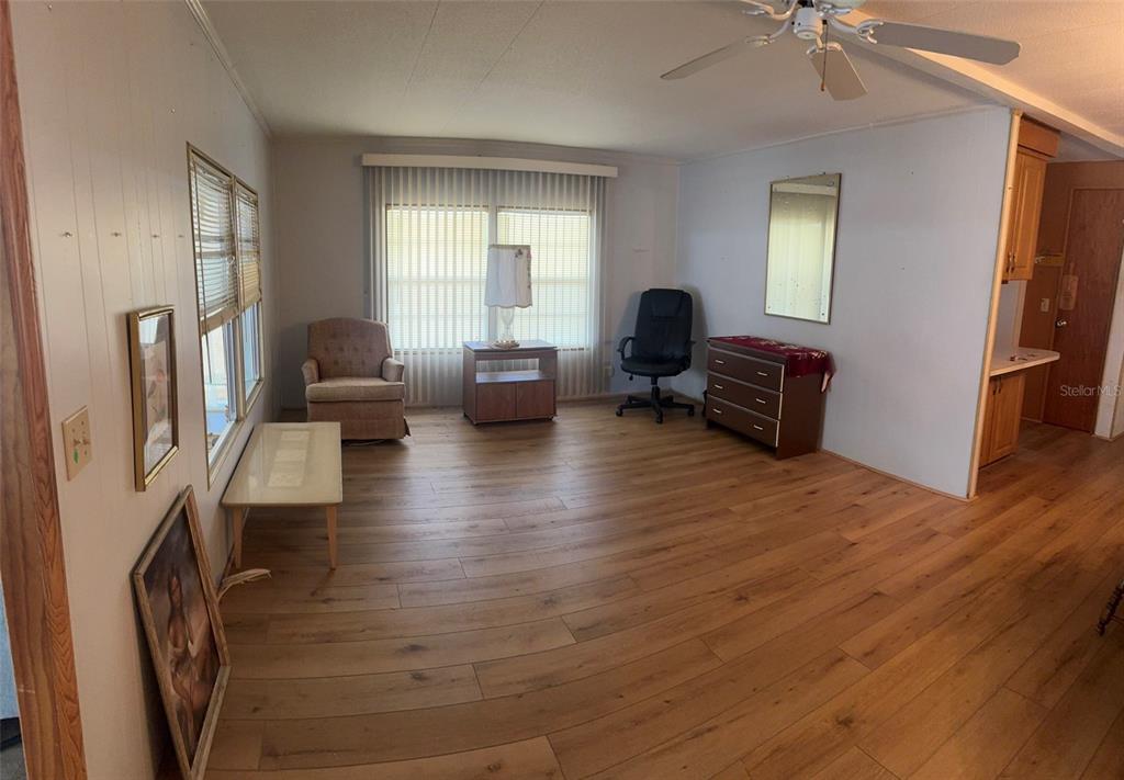 3301 Alt 19, Unit 314 Dunedin, FL 34698 - Photo 3 of 11 a living room with furniture and a wooden floor