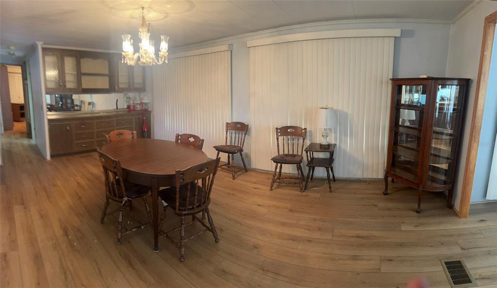 3301 Alt 19, Unit 314 Dunedin, FL 34698 - Photo 4 of 11 a view of a dining room with furniture and chandelier