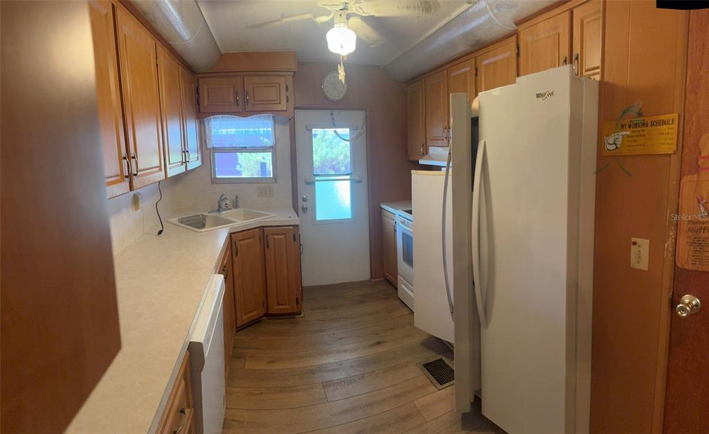 3301 Alt 19, Unit 314 Dunedin, FL 34698 - Photo 5 of 11 a kitchen with refrigerator a washer and dryer