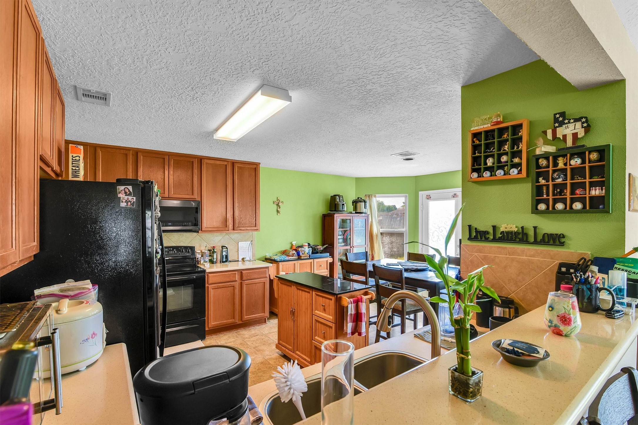 3003 Legends York Drive Spring, TX 77386 - Photo 13 of 29 a kitchen with a refrigerator and a dining table