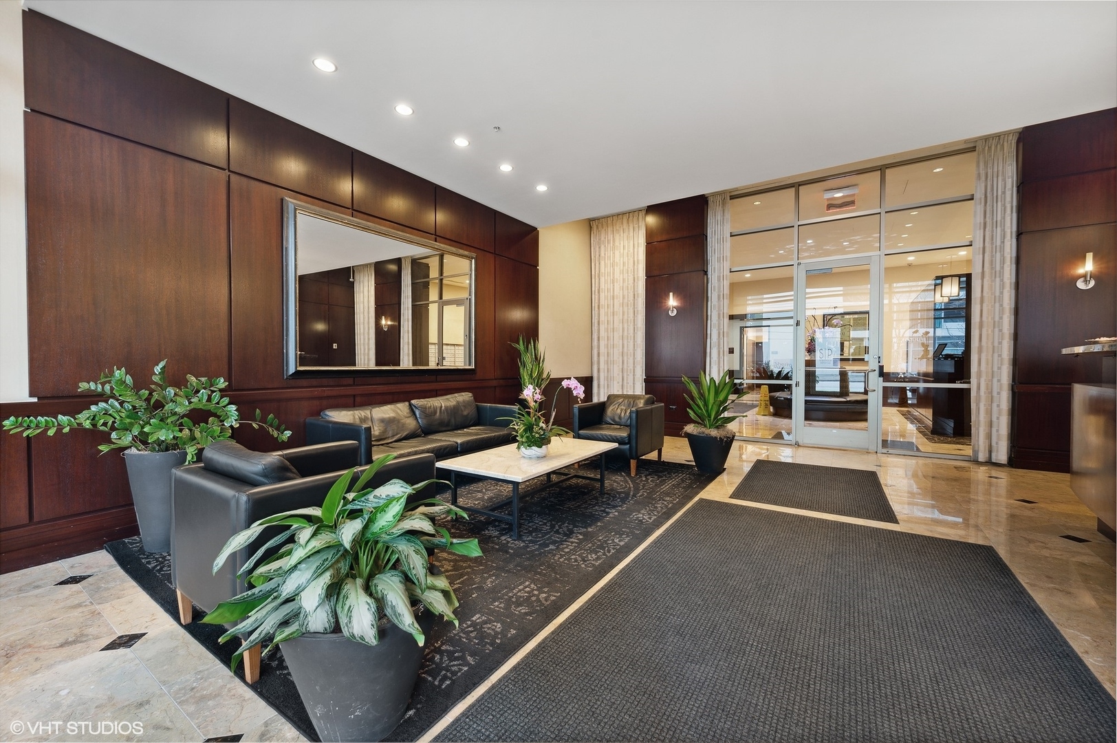 807 Davis Street, Unit 1610 Evanston, IL 60201 - Photo 3 of 19 a lobby with furniture and potted plants