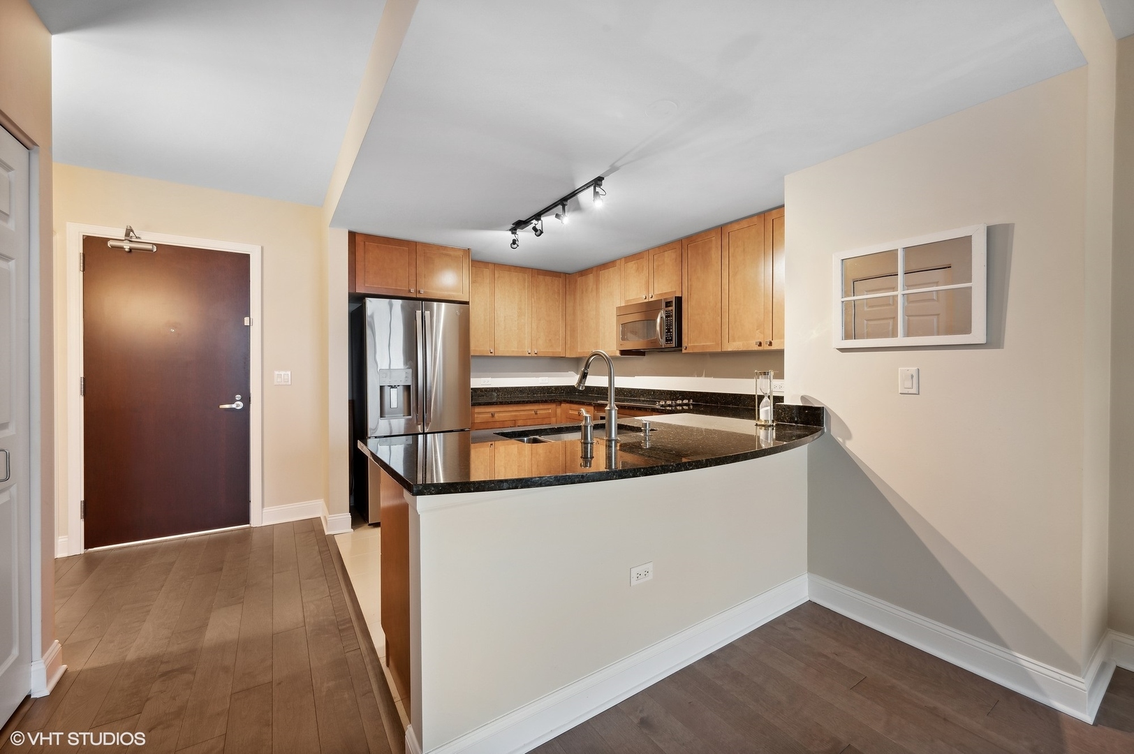 807 Davis Street, Unit 1610 Evanston, IL 60201 - Photo 7 of 19 a kitchen with stainless steel appliances a sink stove and refrigerator