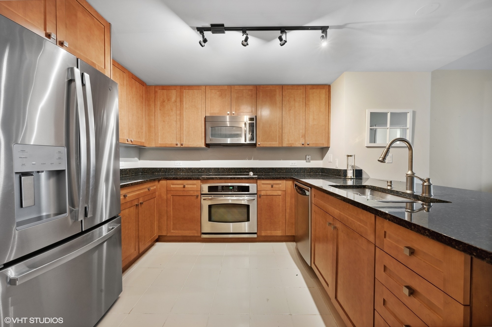 807 Davis Street, Unit 1610 Evanston, IL 60201 - Photo 8 of 19 a kitchen with stainless steel appliances a sink stove and refrigerator