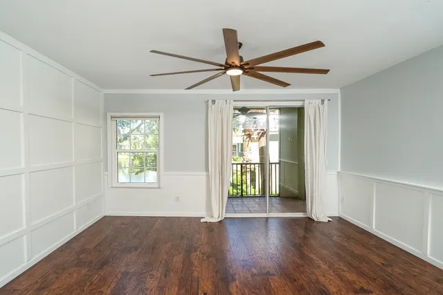 a view of living room with furniture and a ceiling fan