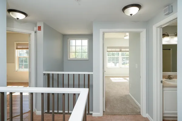a view of a swimming pool with a yard and palm trees