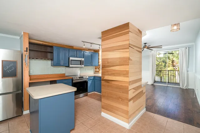 a kitchen with a refrigerator and a stove top oven