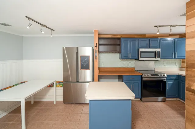 a kitchen with stainless steel appliances a refrigerator and a refrigerator