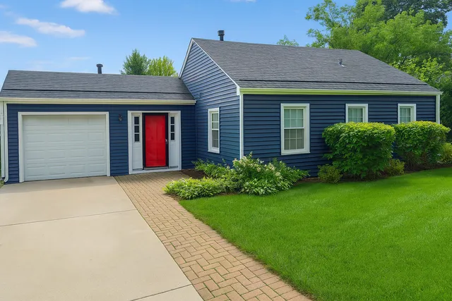 a view of a house with garden and yard