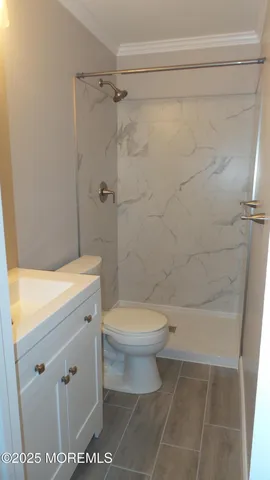 a bathroom with a toilet a sink and shower