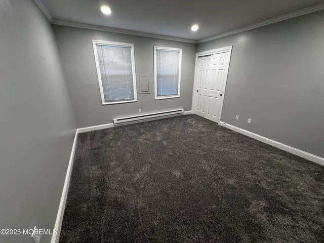 an empty room with windows and closet