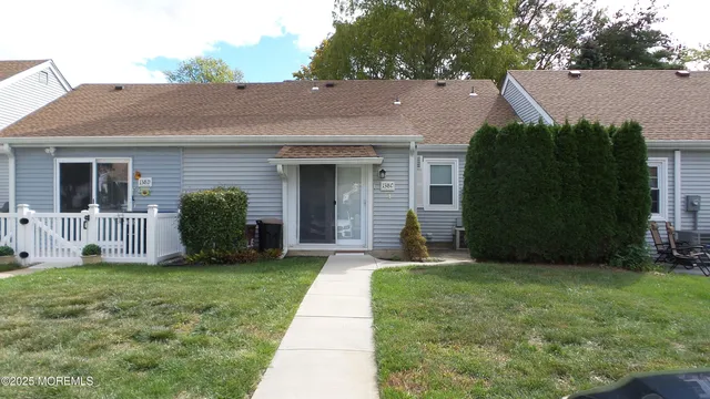 a view of a house with a yard and a garden