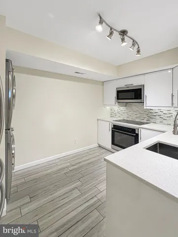 a kitchen with granite countertop a stove and a sink