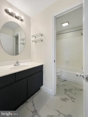 a bathroom with a double vanity sink mirror and shower