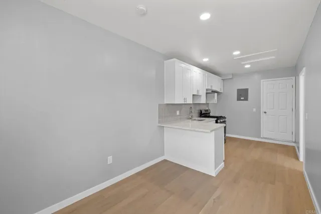 a kitchen with granite countertop white cabinets and white appliances