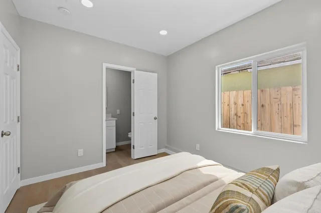 a bedroom with bed and night stand