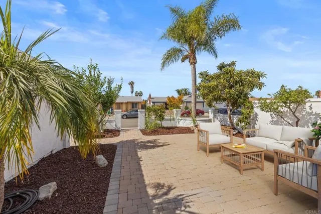 a row of palm trees in front of a house