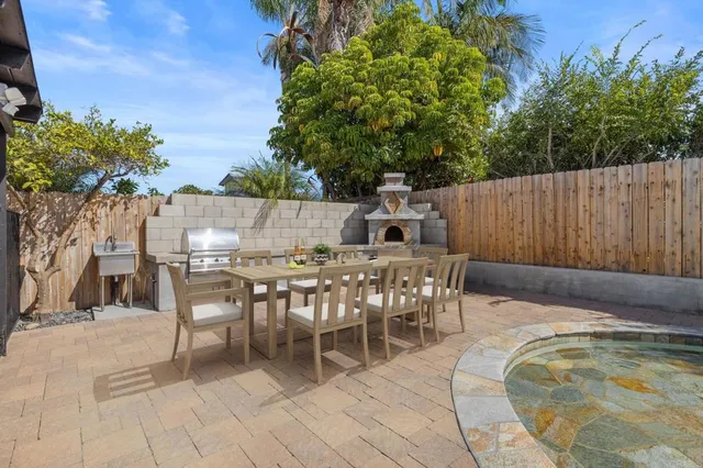 a view of a backyard with a small cabin and wooden fence