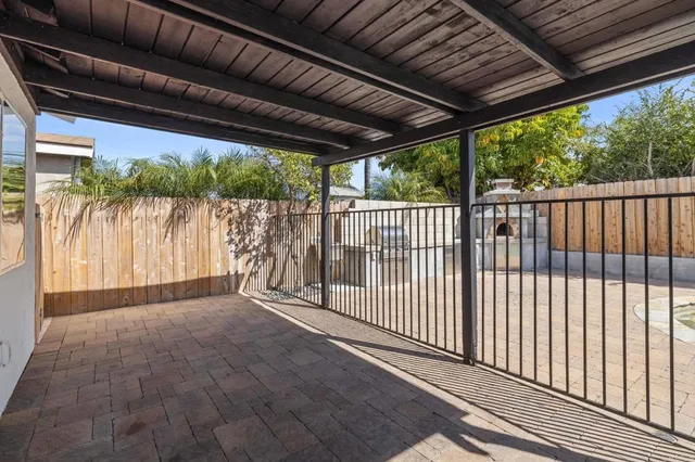a view of a patio with couches chairs and wooden floor
