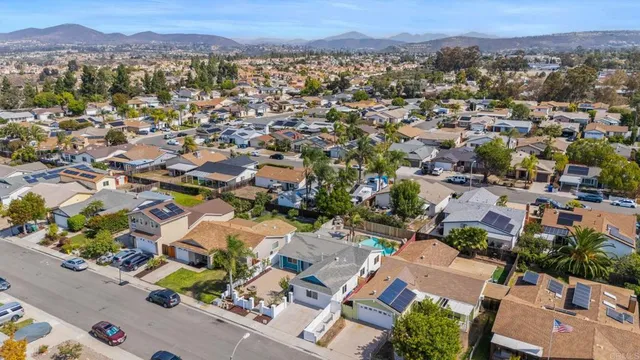 an aerial view of a house with outdoor space and tennis court