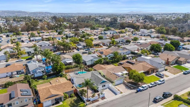 an aerial view of residential house with outdoor space and parking