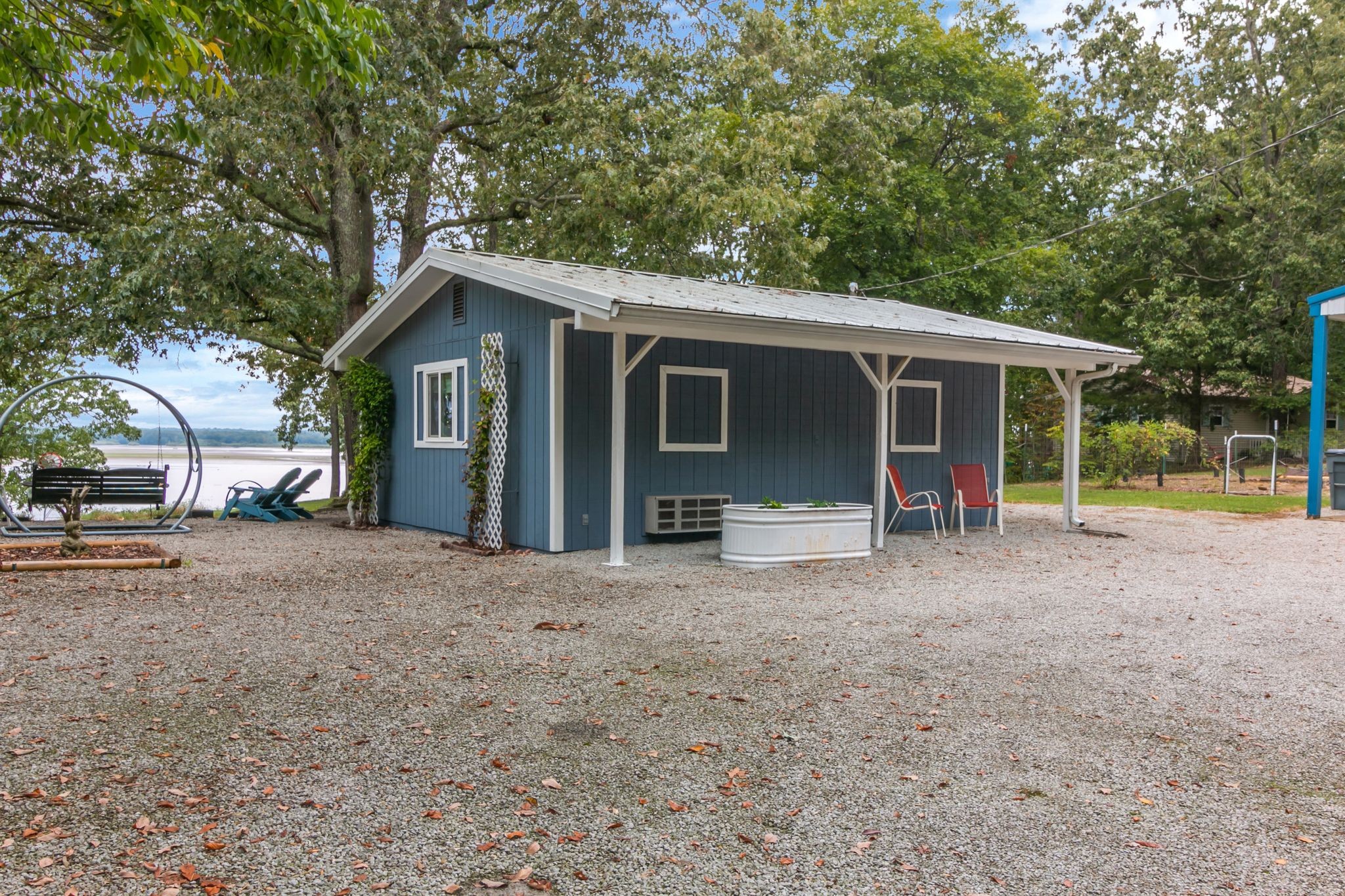 439 Bluff Road Big Sandy, TN 38221 - Photo 7 of 86 a view of a house with a backyard and a large tree