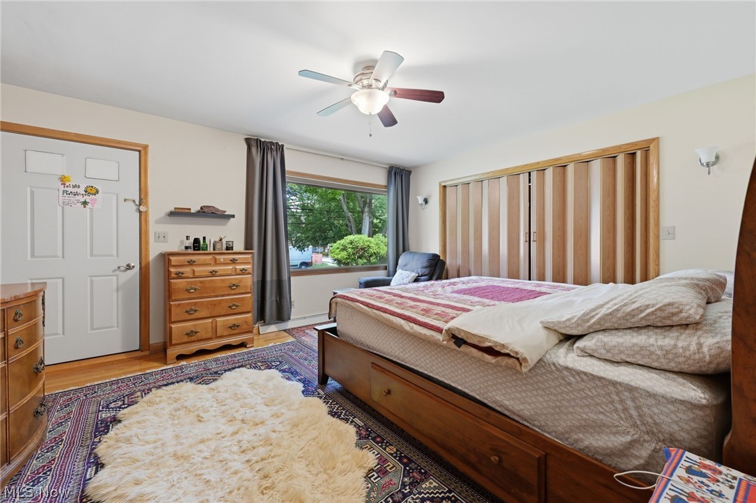 1499 Morris Road Kent, OH 44240 - Photo 3 of 41 Bedroom featuring wood-finish flooring, a ceiling fan with integrated lighting, and a window with exterior visibility