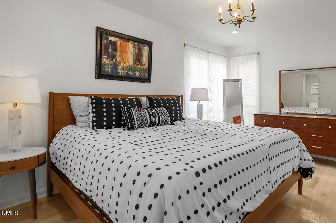 504 Waterside Drive Carrboro, NC 27510 - Photo 29 of 48 a bedroom with a large bed and a chandelier