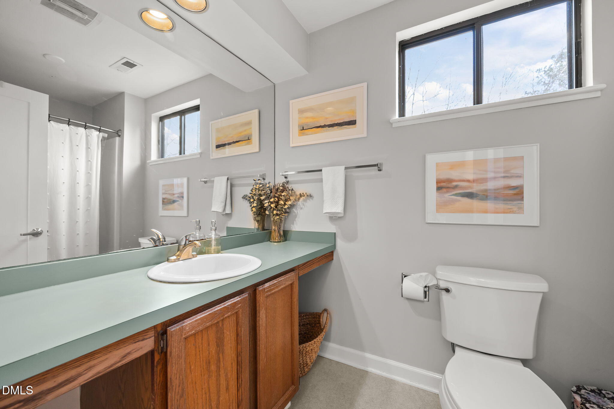 504 Waterside Drive Carrboro, NC 27510 - Photo 35 of 48 a bathroom with a granite countertop toilet sink and mirror