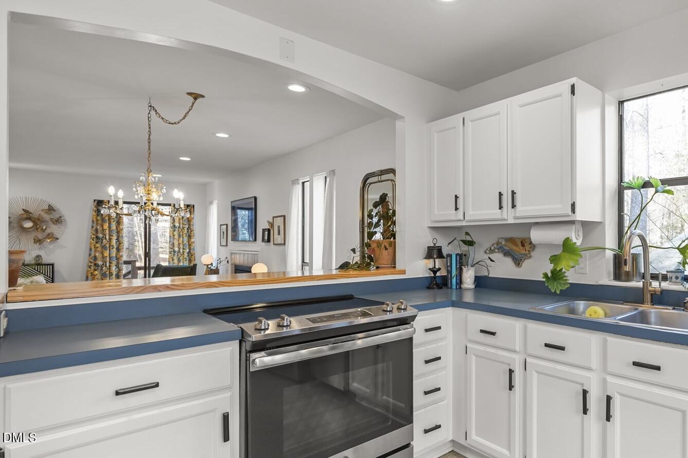 504 Waterside Drive Carrboro, NC 27510 - Photo 8 of 48 a kitchen with white cabinets and appliances