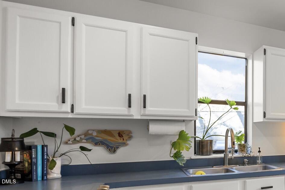 504 Waterside Drive Carrboro, NC 27510 - Photo 9 of 48 a view of cabinets and chair in a kitchen