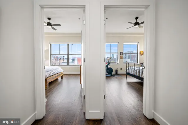 a bedroom with a bed and painting on the wall
